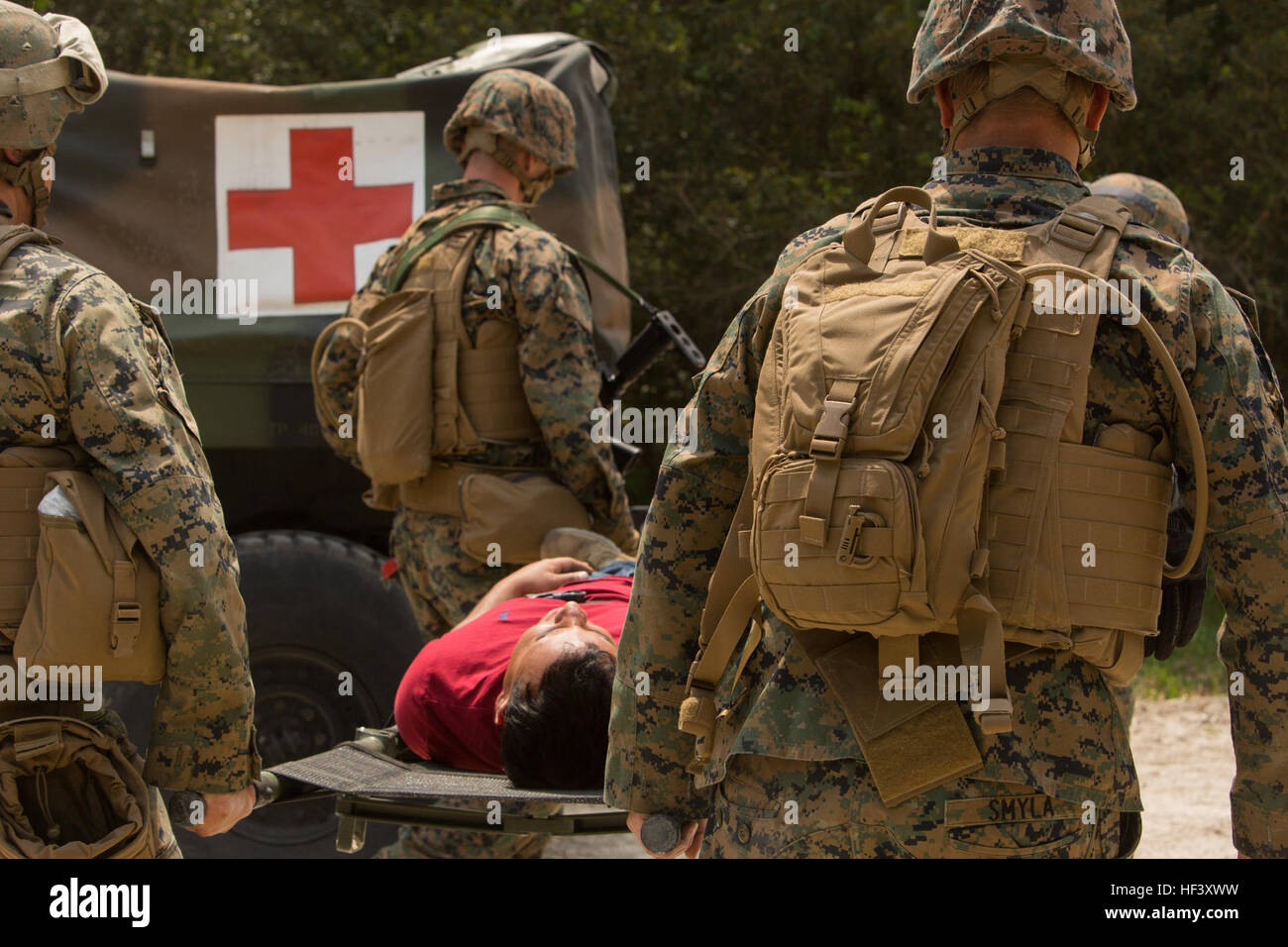 Marines with 2nd Law Enforcement Battalion and Navy Corpsmen carry a ...