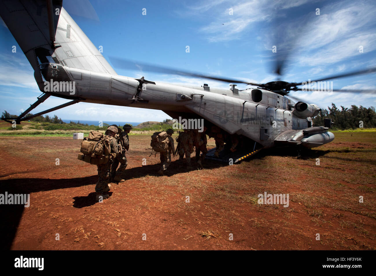 U.S. Marines assigned to 3rd Battalion, 3rd Marine Regiment, board a CH-53E Super Stallion helicopter assigned to Marine Heavy Helicopter Squadron 463 for extraction from Landing Zone Canes, Hawaii, April 29, 2016. HMH-463 conducted personnel extraction and insertion in support of 3rd Battalion, 3rd Marine Regiment during their Marine Corps Combat Readiness Evaluation. (U.S. Marine Corps photo by Lance Cpl. Julian A. Temblador) All Aboard (26214525833) Stock Photo