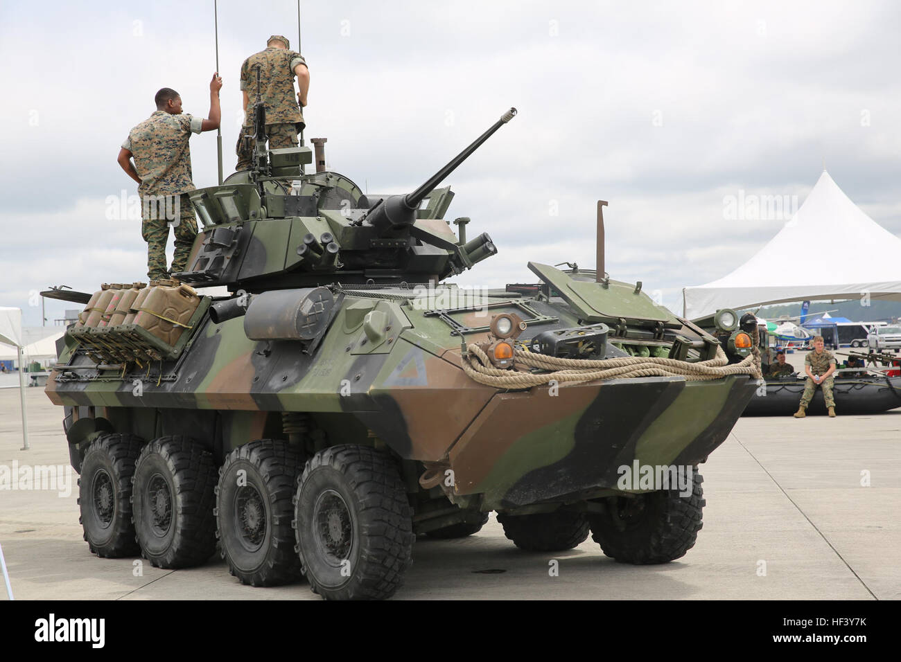Marines stand atop a Light Armored Vehicle display at the 2016 Marine
