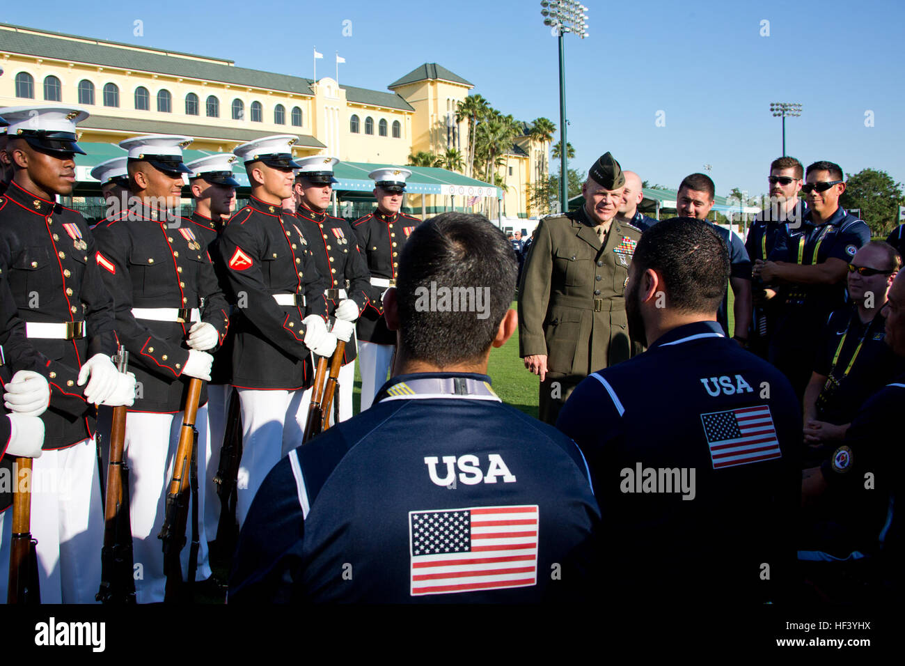 Commandant of the Marine Corps Gen. Robert B. Neller, center right, speaks to Marines with the U.S. Marine Corps Silent Drill Platoon, left, and members of Team USA before the opening ceremony of the Invictus Games at the ESPN Wide World of Sports Complex, Orlando, Fla., May 8, 2016. Team USA has 113 participants competing in 10 adaptive sporting events against 13 other nations. (U.S. Marine Corps photo by Staff Sgt. Gabriela Garcia/Released) CMC at the Invictus Games 160509-M-SA716-036 Stock Photo