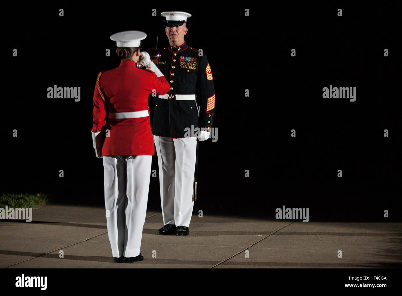 U.S. Marine Corps Staff Sgt. Codie Williams, left, ceremonial bugler, Marine Barracks Washington (MBW), performs with Sgt. Maj. Joseph Gray, command sergeant major of MBW, during an evening parade at MBW, Washington, D.C., May 20, 2016. The evening parade summer tradition began in 1934 and features the Silent Drill Platoon, the U.S. Marine Band, the U.S. Marine Drum and Bugle Corps and two marching companies. More than 3,500 guests attend the parade every week. (U.S. Marine Corps photo by Lance Cpl. Hailey D. Stuart/Released) Marine Barracks Washington Evening Parade May 20, 2016 160520-M-LR22 Stock Photo