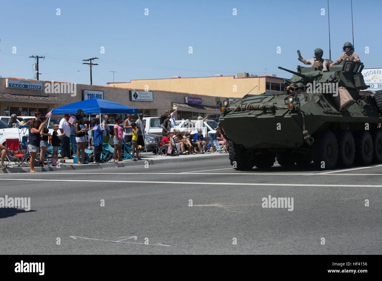 Marines with 3rd Light Armored Reconnaissance Battalion wave to parade