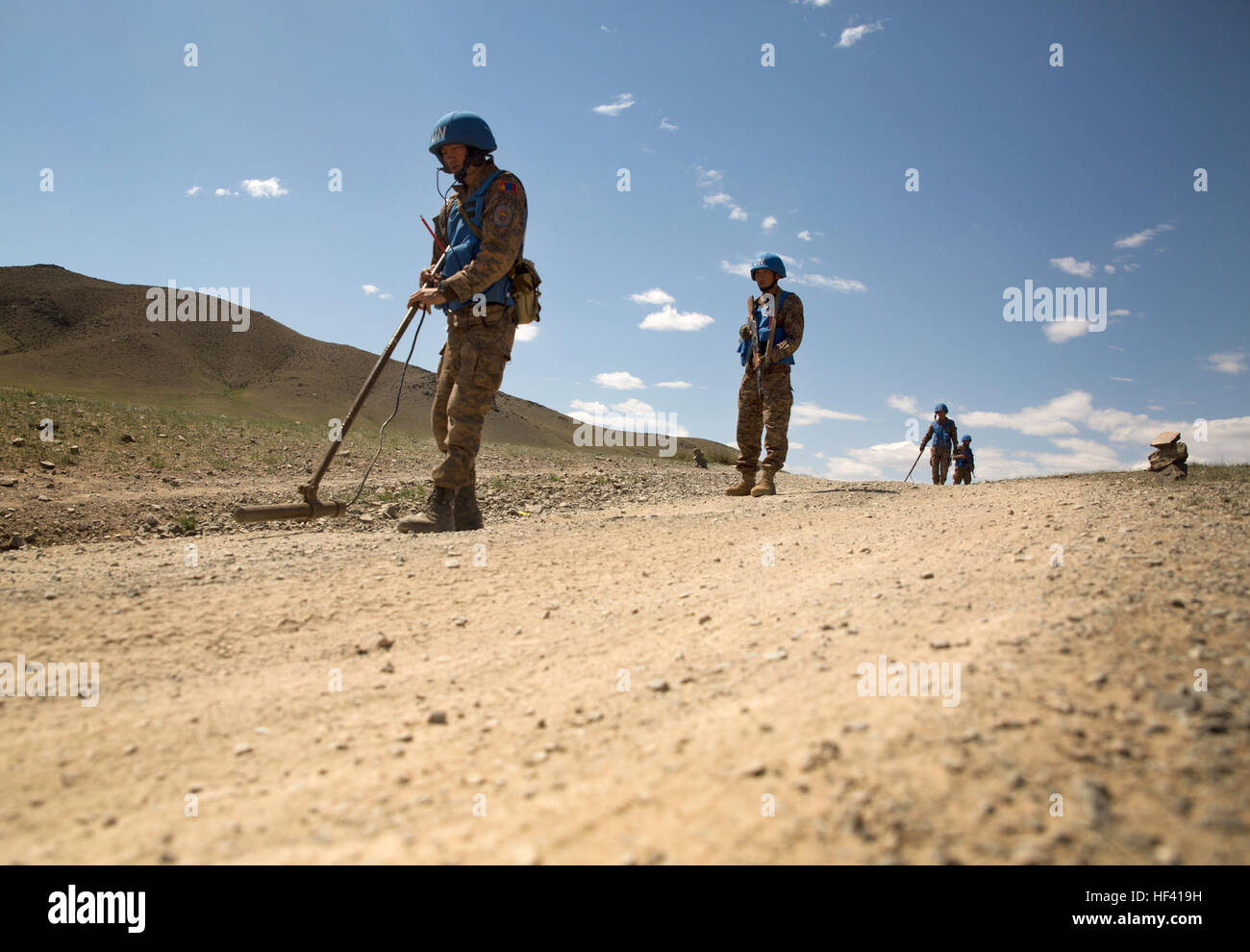 Members of the Mongolian Armed Forces sweep for mines to clear a path for their convoy during the culiminating event of a mine clearance and counter-IED training course of Khaan Quest 2016 at Five Hills Training Area near Ulaanbaatar, Mongolia, June 1. The training provided MAF members with the skills to safely identify and mark potential threats in a minefield, extract personnel and vehicles from minefields and develop IED awareness. Khaan Quest 2016 is an annual, multinational peacekeeping operations exercise hosted by the Mongolian Armed Forces, co-sponsored by U.S. Pacific Command, and sup Stock Photo