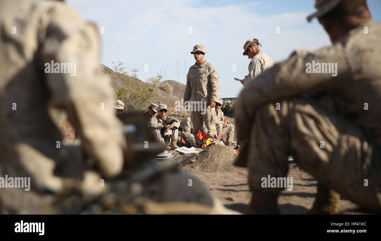 First Lieutenant Geoffrey Ball, a platoon leader with Company K, 3rd Battalion, 7th Marine Regiment, 1st Marine Division walks through his platoon’s assault objective on a terrain model of Morgan’s Well aboard Marine Corps Air Ground Combat Center Twentynine Palms, Calif., June 6, 2016. The assault was a small portion of the battalion’s Marine Corps Combat Readiness Evaluation which prepared the Marines for their upcoming deployment later this year. (U.S. Marine Corps photo by Lance Cpl. Timothy Valero/ Released) 3rd Battalion 7th Marines prepare for deployment 160608-M-HF454-127 Stock Photo