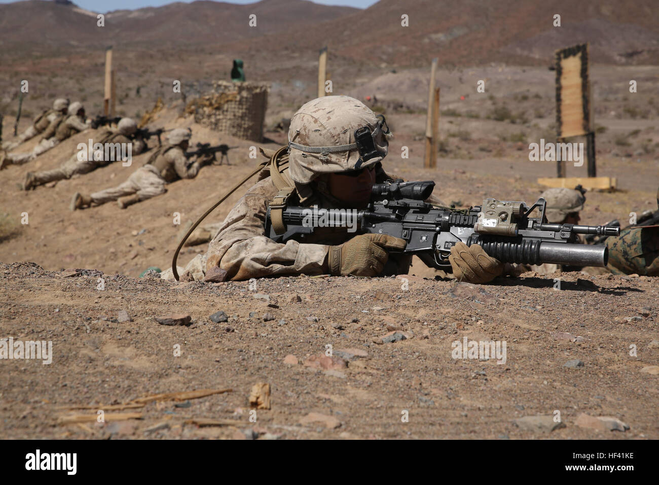 Lance Corporal Oscar Jimenez, a rifleman with Company L, 3rd Battalion, 7th Marine Regiment, 1st Marine Division provides security after his squad clears a trench during an assault aboard Marine Corps Air Ground Combat Center Twentynine Palms, Calif., June 8, 2016.  The Marines were being tested in a Marine Corps Combat Readiness Evaluation, which prepares them for their upcoming deployment with the Special Purpose Marine Air-Ground Task Force – Crisis Response – Central Command. (U.S. Marine Corps photo by Lance Cpl. Timothy Valero/ Released) 3rd Battalion 7th Marines prepare for deployment 1 Stock Photo