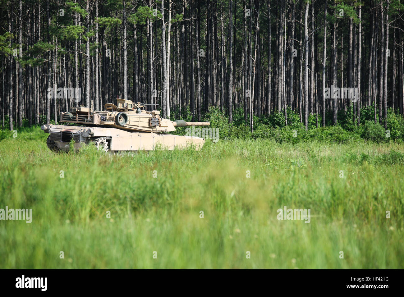 An M1A1 Abrams Main Battle Tank with 2nd Tank Battalion, 2nd Marine Division, scans its surroundings during a semi-annual gunnery at Camp Lejeune, N.C., Jun. 16, 2016.  The M1A1 Abrams brings superior firepower to the battlefield, enabling the infantry to close with and destroy enemy troops. (U.S. Marine Corps photo by Cpl. Samuel Guerra/Released) Path of destruction, 2nd Tanks head down range for gunnery qualification 160616-M-GL218-032 Stock Photo