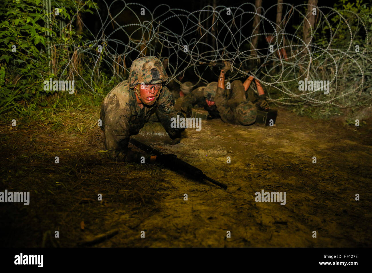 Marines with 2nd Combat Engineer Battalion low crawl through barbed Marines with 2nd Combat Engineer Battalion low crawl through barbed