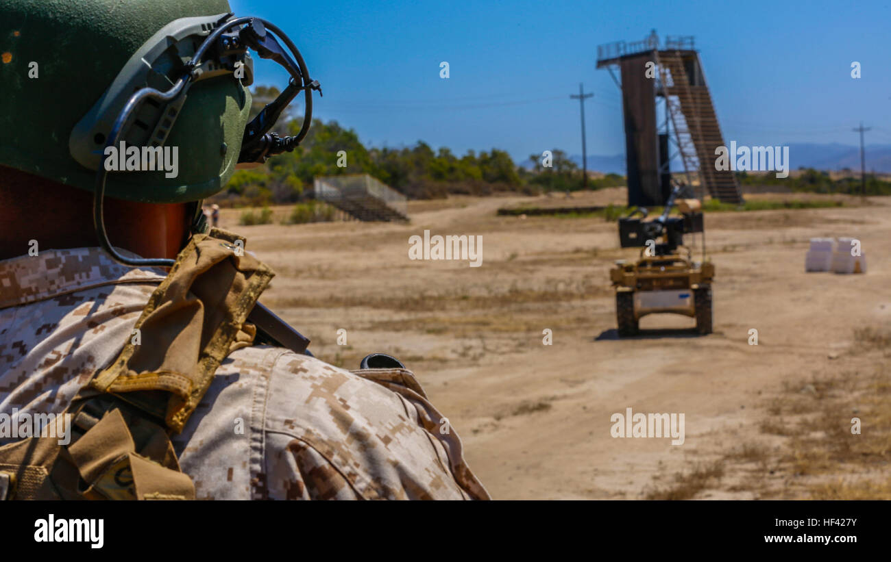 Lance Cpl. Leonardo Reyes, an infantryman with Kilo Company, 3rd Battalion, 5th Regiment, controls the weapon payload of the robotic vehicle modular system aboard Camp Pendleton, Calif., June 26, 2016. Reyes and other Marines from his unit were learning how to operate the system in preparation of exercise Rim of the Pacific with partner nations. (U.S. Marine Corps photo by Lance Cpl. Frank Cordoba/Released) R2-D2 Now With Attitude 160623-M-DJ953-723 Stock Photo