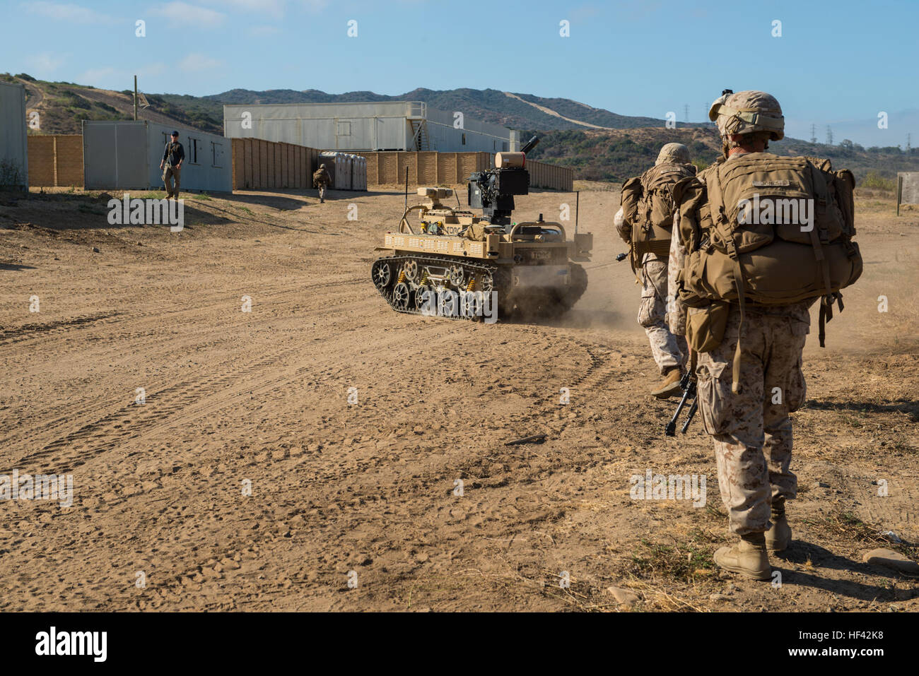 Marines with 3rd Battalion, 5th Marine Regiment conduct a patrol with a Weaponized Multi-Utility Tactical Transport vehicle at Marine Corps Base Camp Pendleton, Calif., July 13, 2016. The system is a multifunction force multiplier configured to persist, protect and project the small unit was built by the Marine Corps Warfighting Laboratory. The lab is conducting a Marine Air-Ground Task Force Integrated Experiment in conjunction with Rim of the Pacific exercise to explore new gear and assess its capabilities for potential future use. The Warfighting Lab identifies possible challenges of the fu Stock Photo