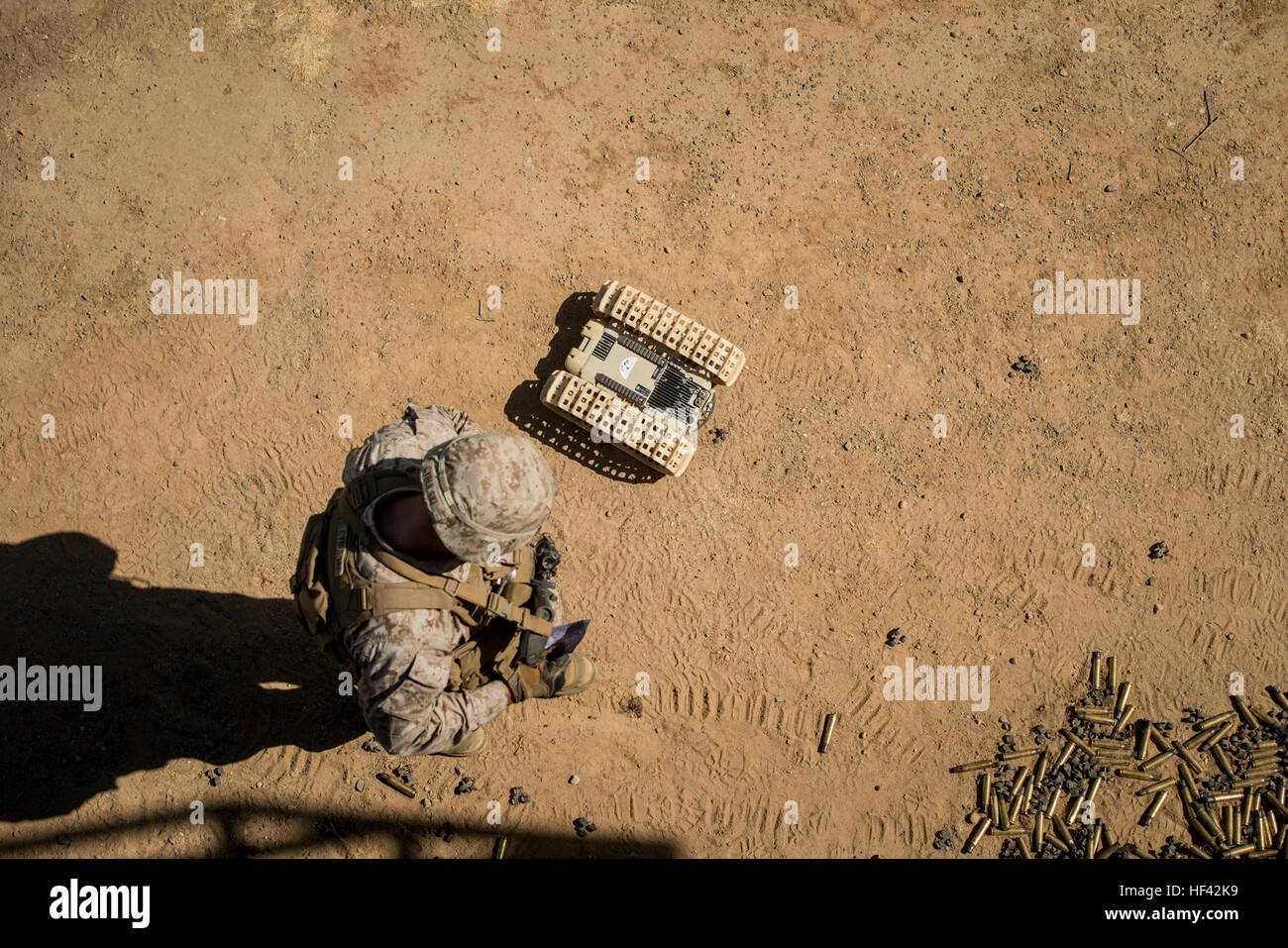 A Marine with 3rd Battalion, 5th Marine Regiment looks down at a “dragon fire” at Marine Corps Base Camp Pendleton, Calif., July 13, 2016. The system, meant to increase initial visibility of the enemy before the Marines need to engage them, was built by the Marine Corps Warfighting Laboratory. It can be tossed and kicked around, is invertible with front and rear cameras, and is both day and night capable. The lab is conducting a Marine Air-Ground Task Force Integrated Experiment in conjunction with Rim of the Pacific exercise to explore new gear and assess its capabilities for potential future Stock Photo