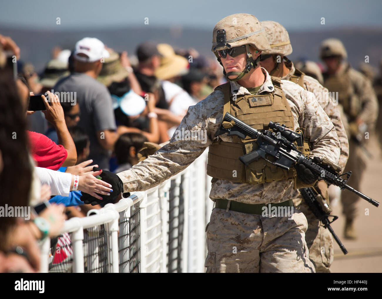 U.S. Marine Corps Sgt. Charles W. Duke from 3rd Battalion, 5th Marine Regiment, 1st Marine Division, interacts with the crowd while participating in the Marine Air Ground Task Force demonstration during the 2016 Marine Corps Air Station (MCAS) Miramar Air Show on MCAS Miramar, Calif., Sept. 23, 2016. The MCAS Miramar Air Show honors 100 years of the Marine Corps Reserves by showcasing aerial prowess of the Armed Forces and their appreciation of civilian community support to the troops. (U.S. Marine Corps photo by Sgt. Tia Dufour/Released) 160923-M-KS211-363 (29669966900) Stock Photo