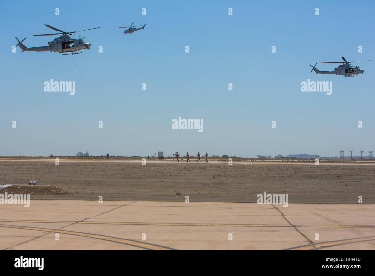 U.S. Marines with 1st Marine Division, conduct fast roping drills from UH-1Y Venom helicopter’s during the Marine Air Ground Task Force demonstration at the 2016 Marine Corps Air Station (MCAS) Miramar Air Show at MCAS Miramar, Calif., Sept. 23, 2016. The MCAS Miramar Air Show honors 100 years of the Marine Corps Reserves by showcasing aerial prowess of the Armed Forces and their appreciation of the civilian community’s support to the troops. (U.S. Marine Corps photo By Corporal Jessica Y. Lucio/Released) MCAS Miramar Air Show 160923-M-UX416-071 Stock Photo