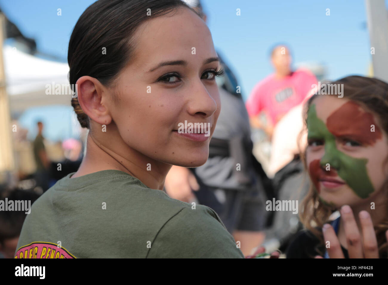 U.S. Marine Lance Cpl. Cameo Prusheik with Marine Air Support Squadron 6, 4th Marine Air Wing, applies camouflage paint on the faces of patrons attending the 2016 Marine Corps Air Station Miramar Air Show at MCAS Miramar, Calif., Sept. 24, 2016. The Air Show marks 100 years of Marine Corps Reserves by showcasing prowess of the armed forces and their appreciation of the civilian community’s support for the troops. (U.S. Marine Corps photo by Pfc. Nadia J. Stark/Not Released) 2016 MCAS Miramar Air Show 160924-M-BV291-089 Stock Photo