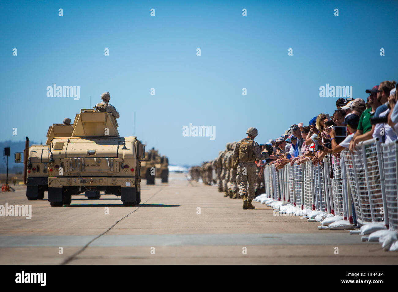 U.S. Marines with 1st Marine Expeditionary Force wave to a crowd of onlookers while executing a mounted foot patrol as part of the Marine Air Ground Task Force (MAGTF) demonstration during the 2016 Marine Corps Air Station (MCAS) Miramar Air Show at MCAS Miramar, Calif., Sept. 24, 2016. The MCAS Miramar Air Show honors 100 years of the Marine Corps Reserves by showcasing aerial prowess of the Armed Forces and their appreciation of the civilian community’s support to the troops. (U.S. Marine Corps photo By Corporal Jessica Y. Lucio/Released) MCAS Miramar Air Show 160924-M-UX416-031 Stock Photo