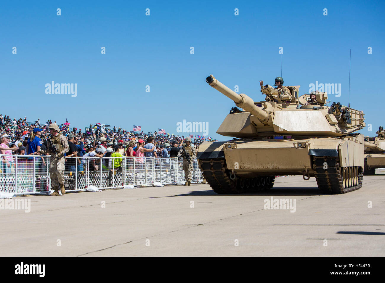 U.S. Marines with 1st Marine Expeditionary Force wave to the a crowd of onlookers while passing by aboard their M1 A2 Abrams tank as part of the Marine Air Ground Task Force (MAGTF) demonstration at the 2016 Marine Corps Air Station (MCAS) Miramar Air Show at MCAS Miramar, Calif., Sept. 24, 2016. The MCAS Miramar Air Show honors 100 years of the Marine Corps Reserves by showcasing aerial prowess of the Armed Forces and their appreciation of the civilian community’s support to the troops. (U.S. Marine Corps photo By Corporal Jessica Y. Lucio/Released) MCAS Miramar Air Show 160924-M-UX416-033 Stock Photo