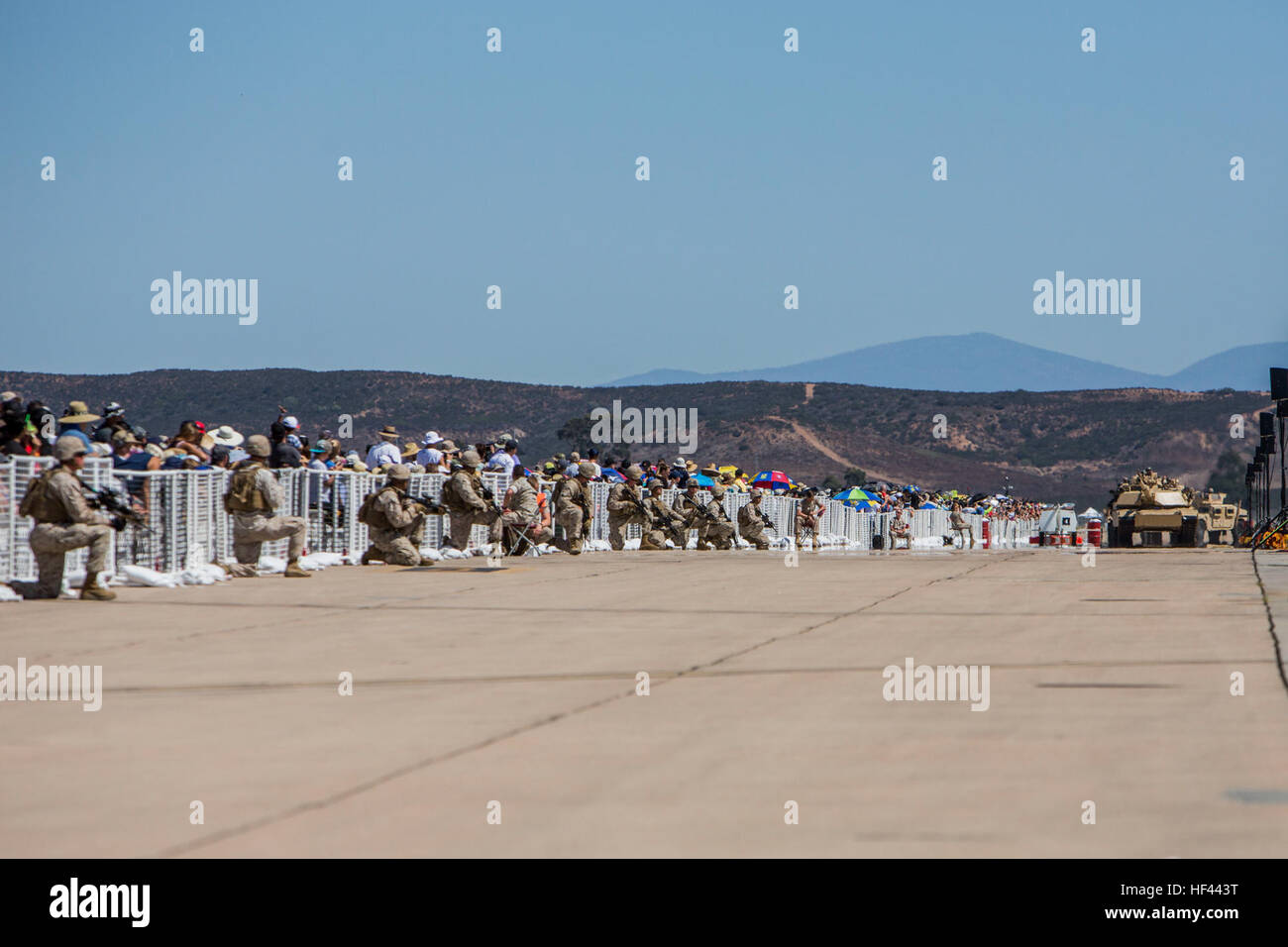 U.S. Marines execute a security tactic as part of the Marine Air Ground Task Force (MAGTF) demonstration, during the 2016 Marine Corps Air Station (MCAS) Miramar Air Show at MCAS Miramar, Calif., Sept. 24, 2016. The MCAS Miramar Air Show honors 100 years of the Marine Corps Reserves by showcasing aerial prowess of the Armed Forces and their appreciation of the civilian community’s support to the troops. (U.S. Marine Corps photo By Corporal Jessica Y. Lucio/Released) MCAS Miramar Air Show 160924-M-UX416-035 Stock Photo