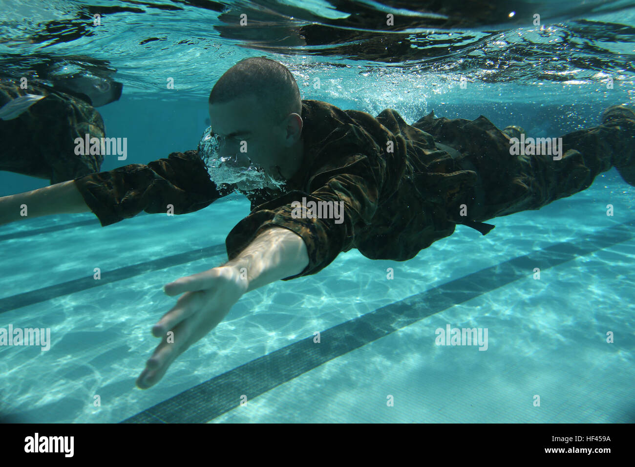 U.S. Marines with Headquarters and Support Battalion, Marine Corps Base Smedley D. Butler, conduct 250 meter swim during an intermediate swim qualification course at Camp Foster, Okinawa, Japan, Oct. 25, 2016. The purpose of the course is to maintain proficiency, and enhance the Marines skills in water survival techniques. (U.S. Marine Corps photo by MCIPAC Combat Camera Lance Cpl. Brooke Deiters) Marine Corps Swim Qual 161025-M-MV819-004 Stock Photo