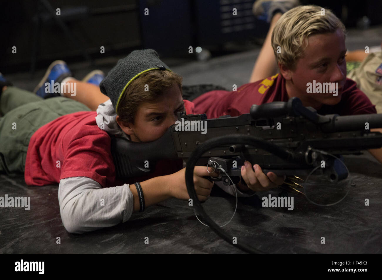 Noah Allen, Boy Scout, Troop 377, fires a M249 Squad Automatic Weapon at the Indoor Simulated Marksmanship Trainer aboard Marine Corps Air Ground Combat Center, Twentynine Palms, Calif., Nov. 5, 2016, during the Boy Scout Camp Out for local Boy Scouts of America troops. (Official Marine Corps photo by Cpl. Medina Ayala-Lo/Released) Combat Center welcomes Boy Scouts of America 161105-M-RO214-425 Stock Photo