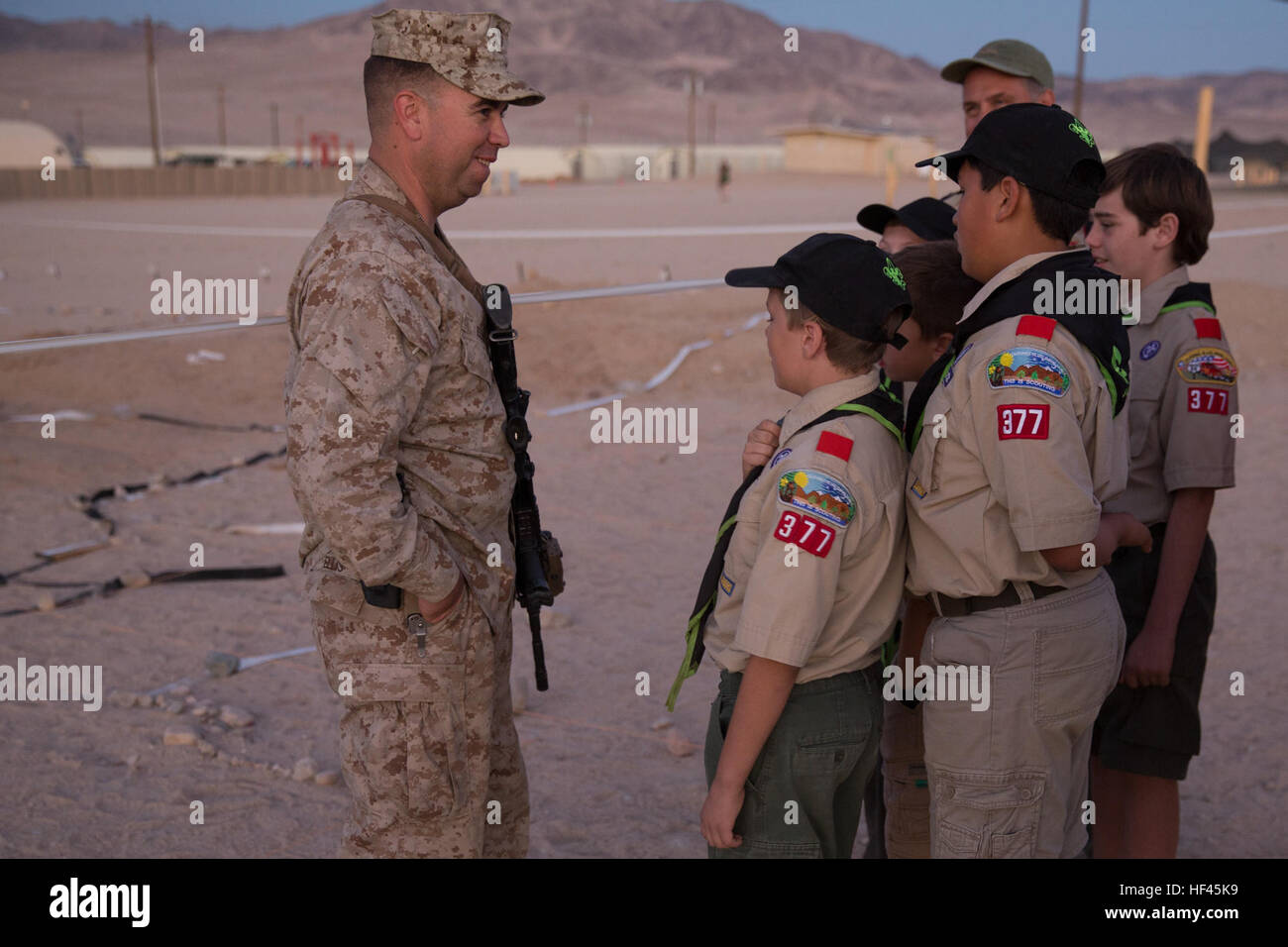 Gunnery Sgt. Kenneth R. Ellis III, company gunnery sergeant, 4th Marine Regiment, answers questions for Boy Scouts of Troop 377 at Camp Wilson aboard Marine Corps Air Ground Combat Center, Twentynine Palms, Calif., Nov. 5, 2016, during the Boy Scout Camp Out for local Boy Scouts of America troops. (Official Marine Corps photo by Cpl. Medina Ayala-Lo/Released) Combat Center welcomes Boy Scouts of America 161105-M-RO214-934 Stock Photo