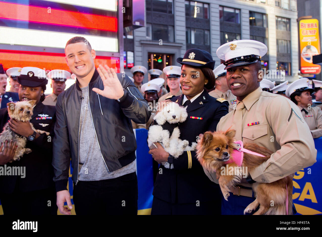 Pfc. Michael Robinson and Sailors hold puppies from the Humane Society of New York with Anthony Rizzo, the first baseman for the Cubs who was also voted most valuable player in the 2016 baseball World Series, on the ABC Good Morning America television show at Times Square in New York City, N.Y., Nov. 11, 2016. Marines and Sailors from the II Marine Expeditionary Force and the USS Iwo Jima are participating in Veterans Week New York City 2016 to honor the service of all our nation’s veterans. (U.S. Marine Corps Photo by Sgt. Anthony Mesa.) ABC Good Morning America Welcomes II MEF Marines 161111 Stock Photo