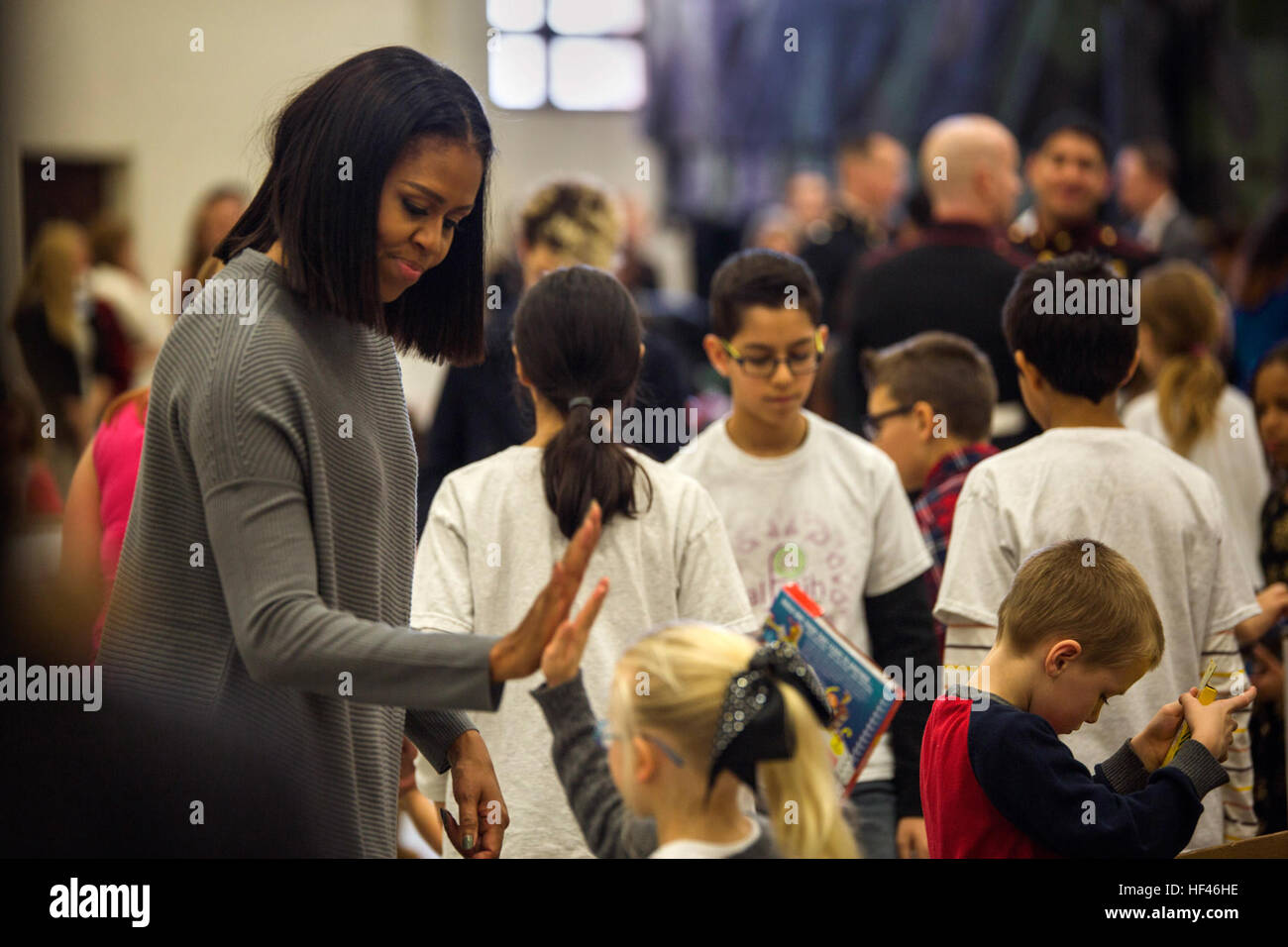 First Lady Michelle Obama high fives a volunteer at a Toys for Tots event at Joint Base Anacostia-Bolling, Washington D.C., Dec. 7, 2016. The Marine Corps Reserve Toys for Tots program was created in 1947 and provides new, unwrapped toys to millions of children across the country every year. The first lady is an avid supporter of Toys for Tots and has been a spokesperson for its mission for the last eight years. (U.S. Marine Corps photo by Lance Cpl. Jamie L. Arzola) Michelle Obama's last Toys for Tots as FLOTUS 161207-M-TB374-004 Stock Photo