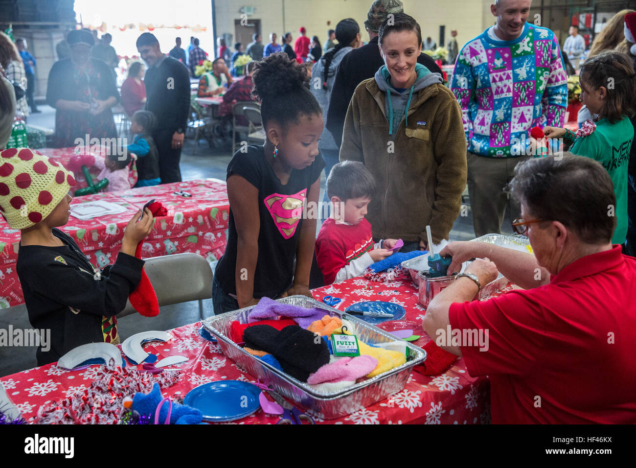 U.S. Marines and their family members decorate sock puppets during the