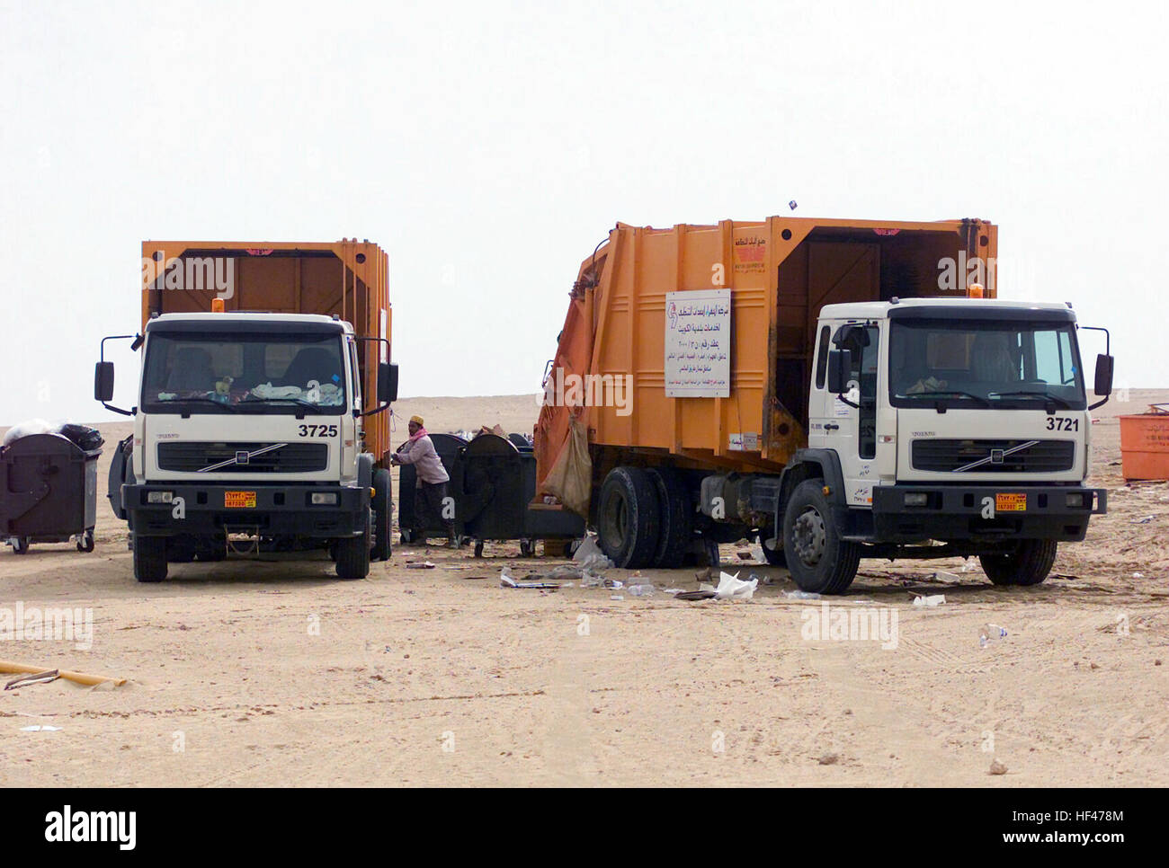 Kuwaiti dump trucks removes trash at Camp Coyote, Kuwait, during