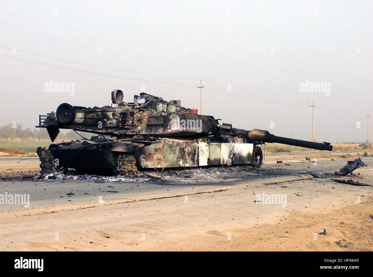 A scuttled M1A1 Abrams Main Battle Tank (MBT) rests in front of a Fedayeen camp just outside of Jaman Al Juburi, Iraq during Operation IRAQI FREEDOM. DM-SD-04-07075 Stock Photo