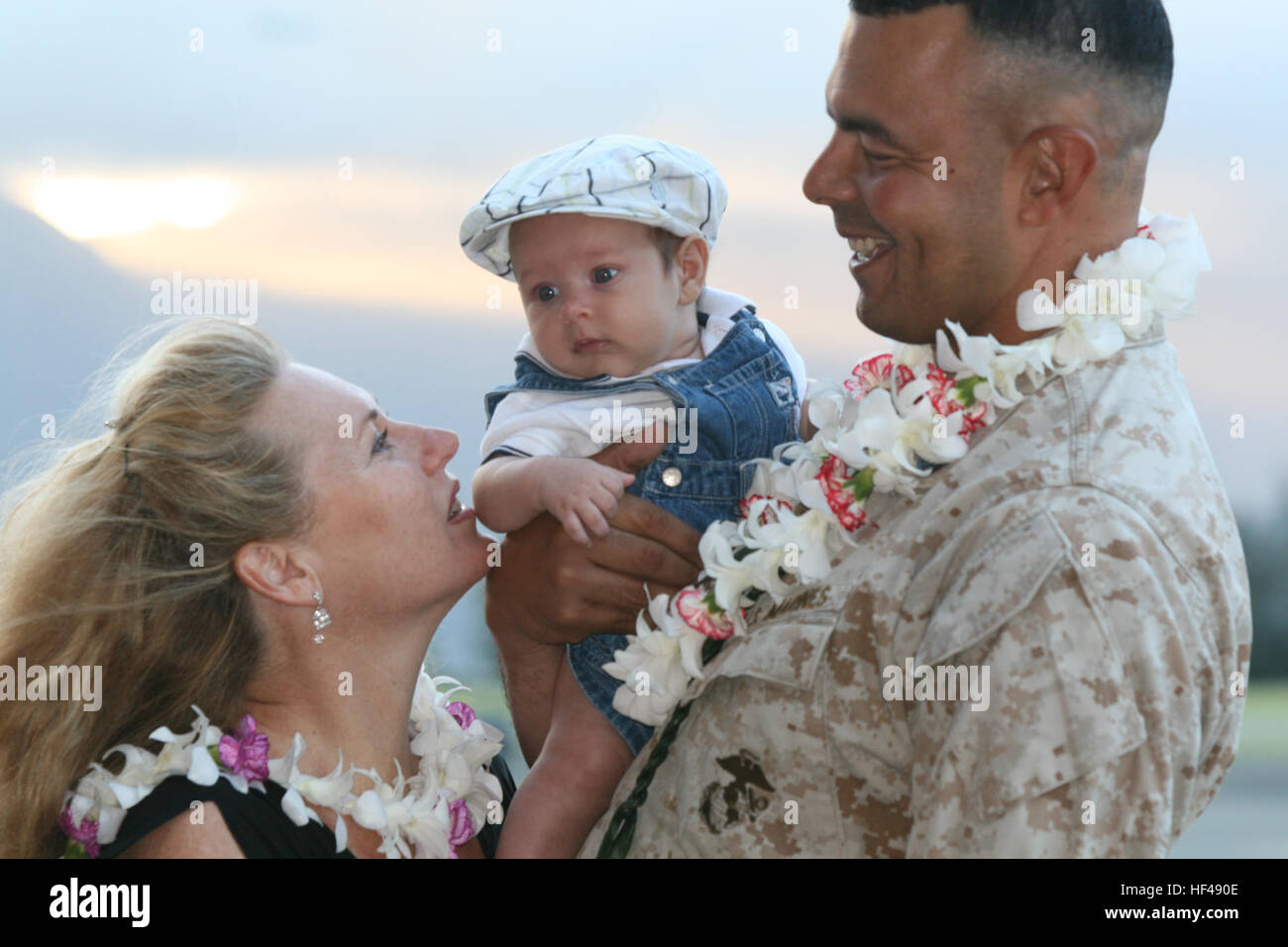 U.S. Marine Corps Master Gunnery Sgt. William Perez, Avionics Officer, Combat Logistics Battalion-3, greets his wife and, for the first time, his newborn son, after arriving with Marine Heavy Helicopter (HMH) Squadron-363 Marines at Marine Corps Air Station Kaneohe Bay, Hawaii, Sept. 13, 2010. Marines and Sailors from HMH-363 returned from a seven month deployment to Afghanistan in support of Operation Enduring Freedom. (U.S. Marine Corps photo by Lance Cpl. Jody Lee Smith/Released) 100913-M-9232S-030 (4993128551) Stock Photo