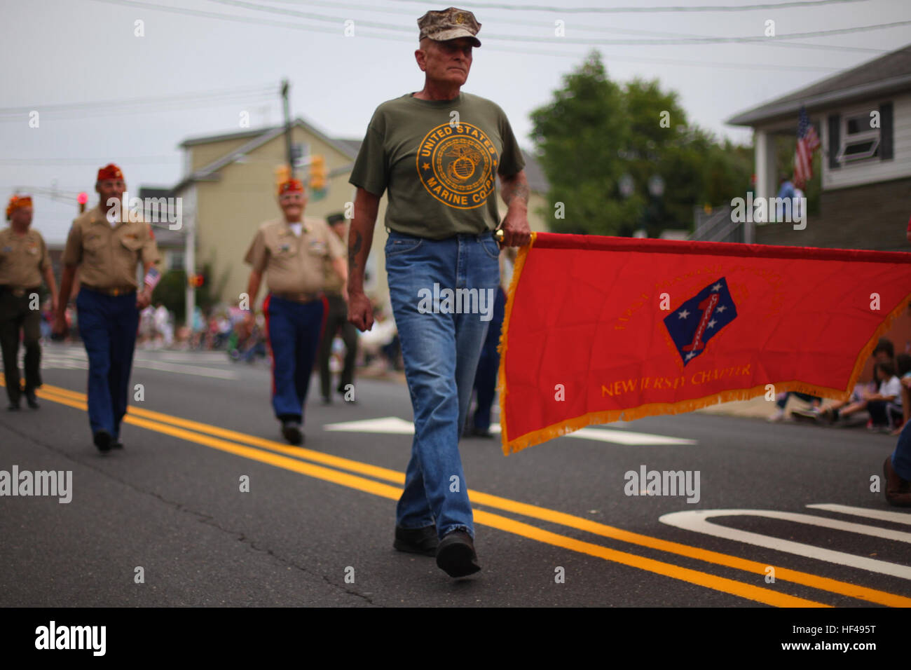 A Marine veteran carry's a banner for the 1st Marine Division during the annual John Basilone Parade, Raritan, N.J., Sept. 26. More than 150 units marched in the parade and city officials estimate 10,000 people came to the small town in New Jersey to honor John and his heroism. Basilone was awarded the Medal of Honor for his actions on Guadalcanal as a member of the 1st Marine Division and then was brought home to help sell war bonds. He requested to return to the Pacific and was killed Feb. 19, 1945. He was awarded the Navy Cross for his last actions giving him the the two highest heroism dec Stock Photo