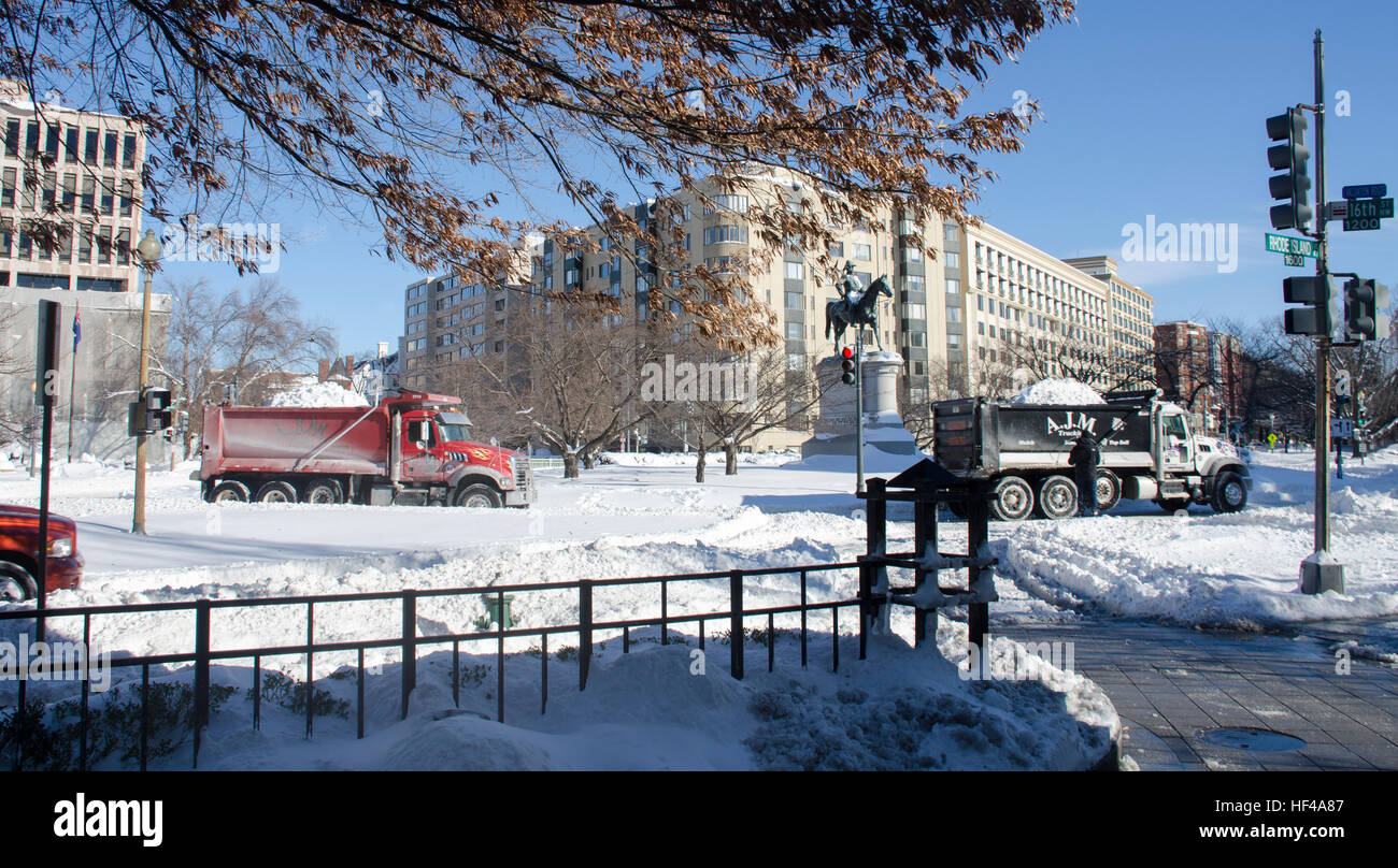 Trucks haul snow around Scott Circle after a blizzard in Washington DC