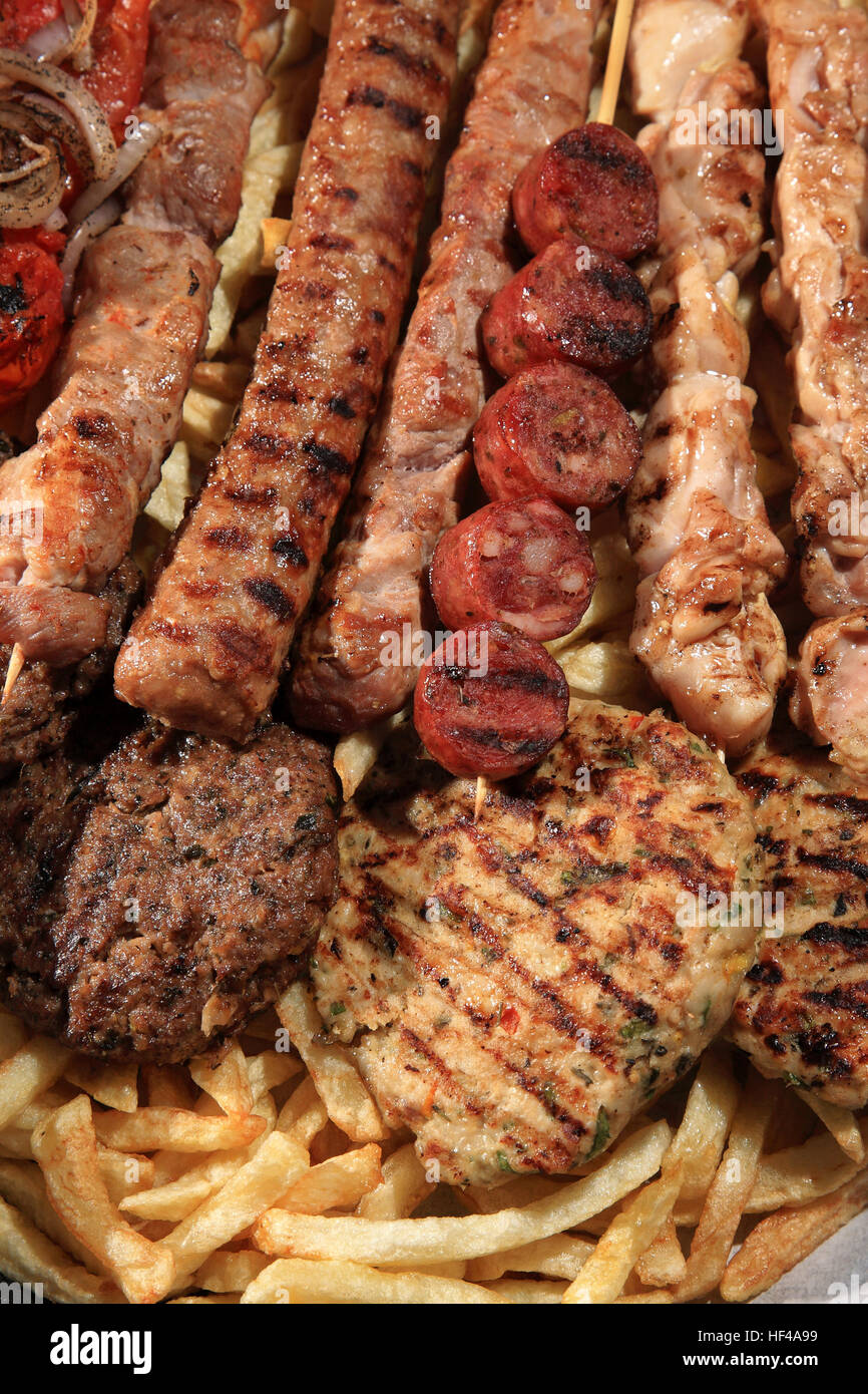 close up of mix grill served on a plate with fried potatoes Stock Photo -  Alamy