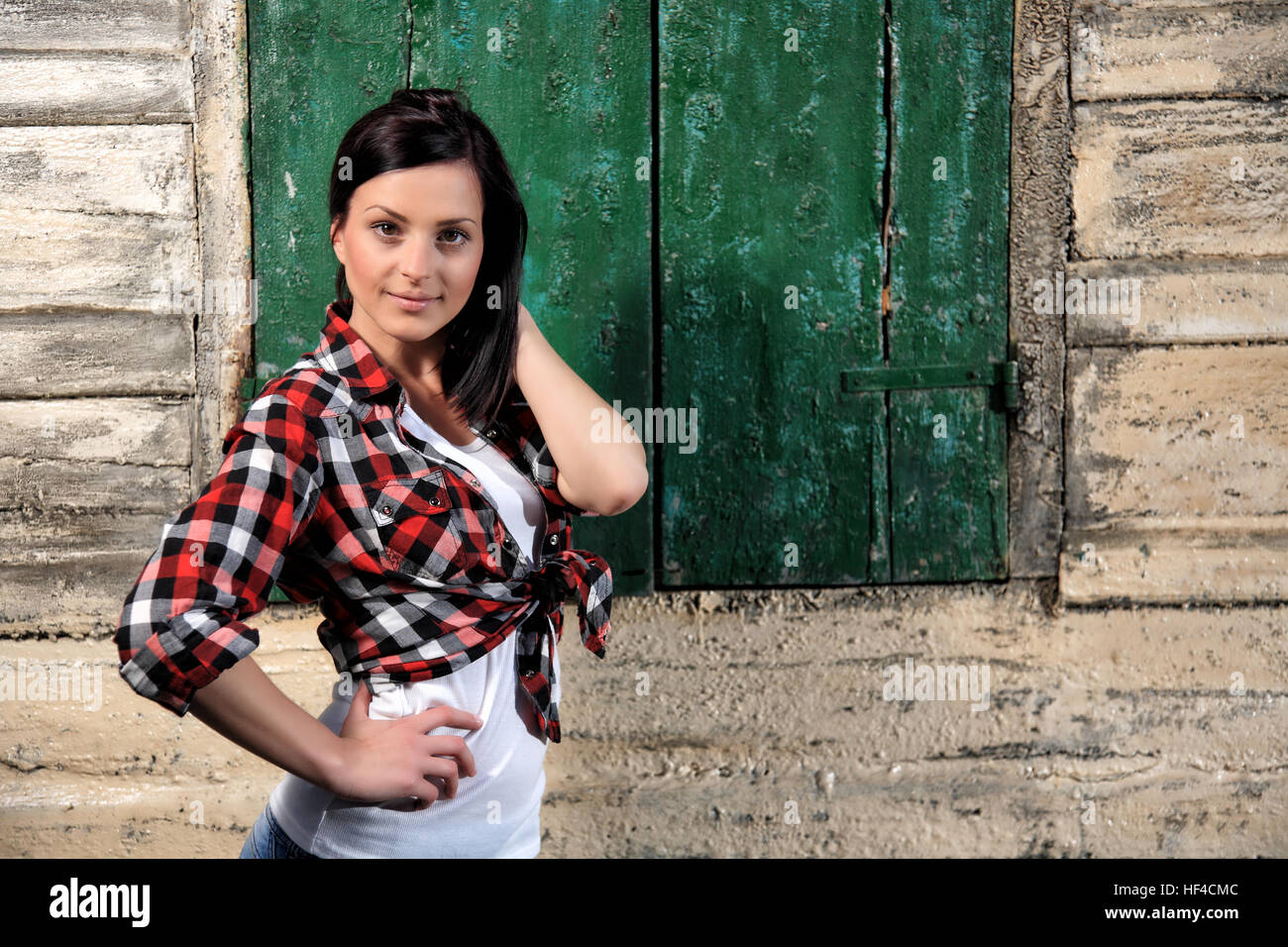 portrait of a beautiful young girl in front of old wooden house Stock ...