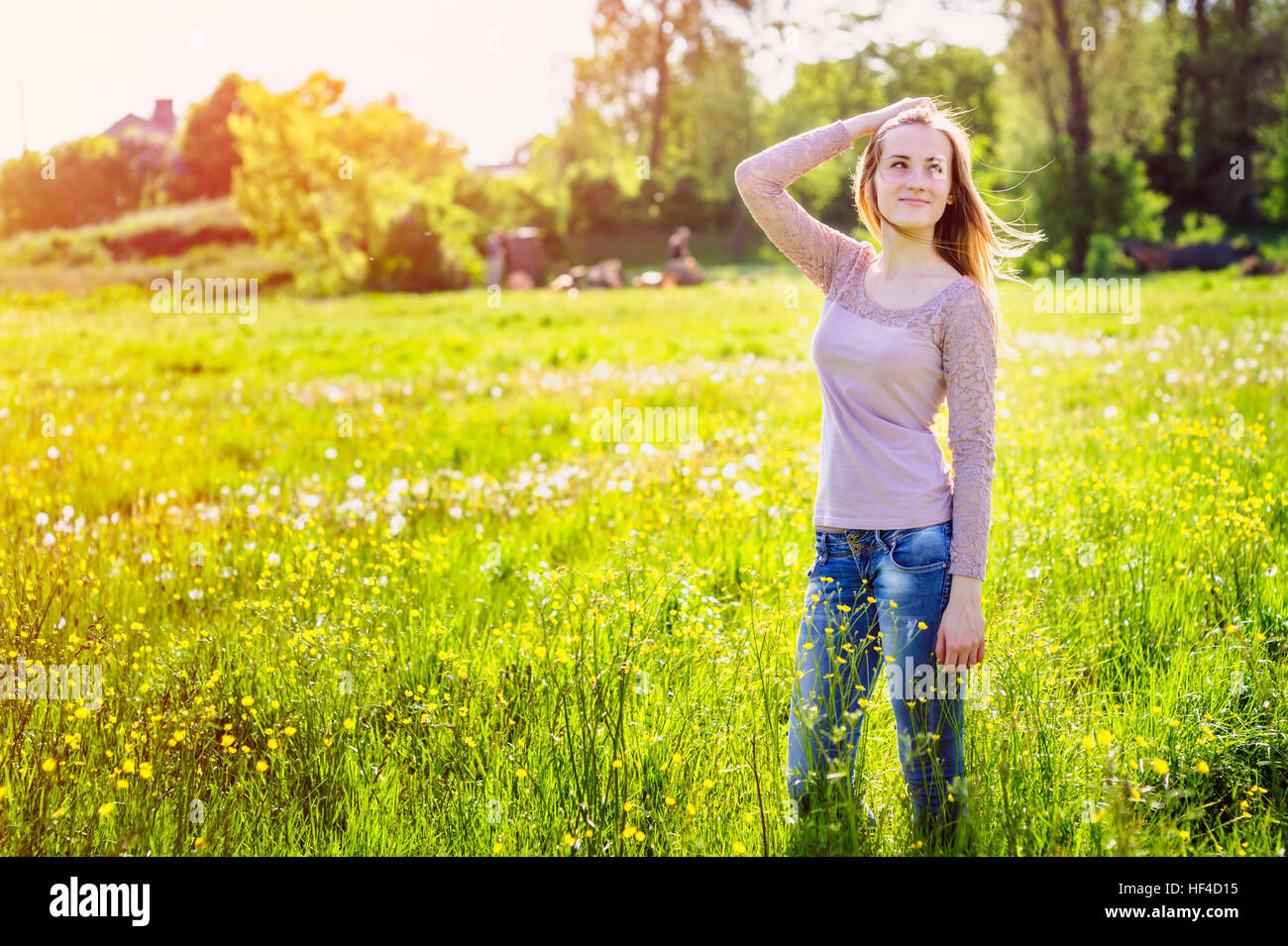 young woman walking in a meadow with yellow wildflowers Stock Photo - Alamy