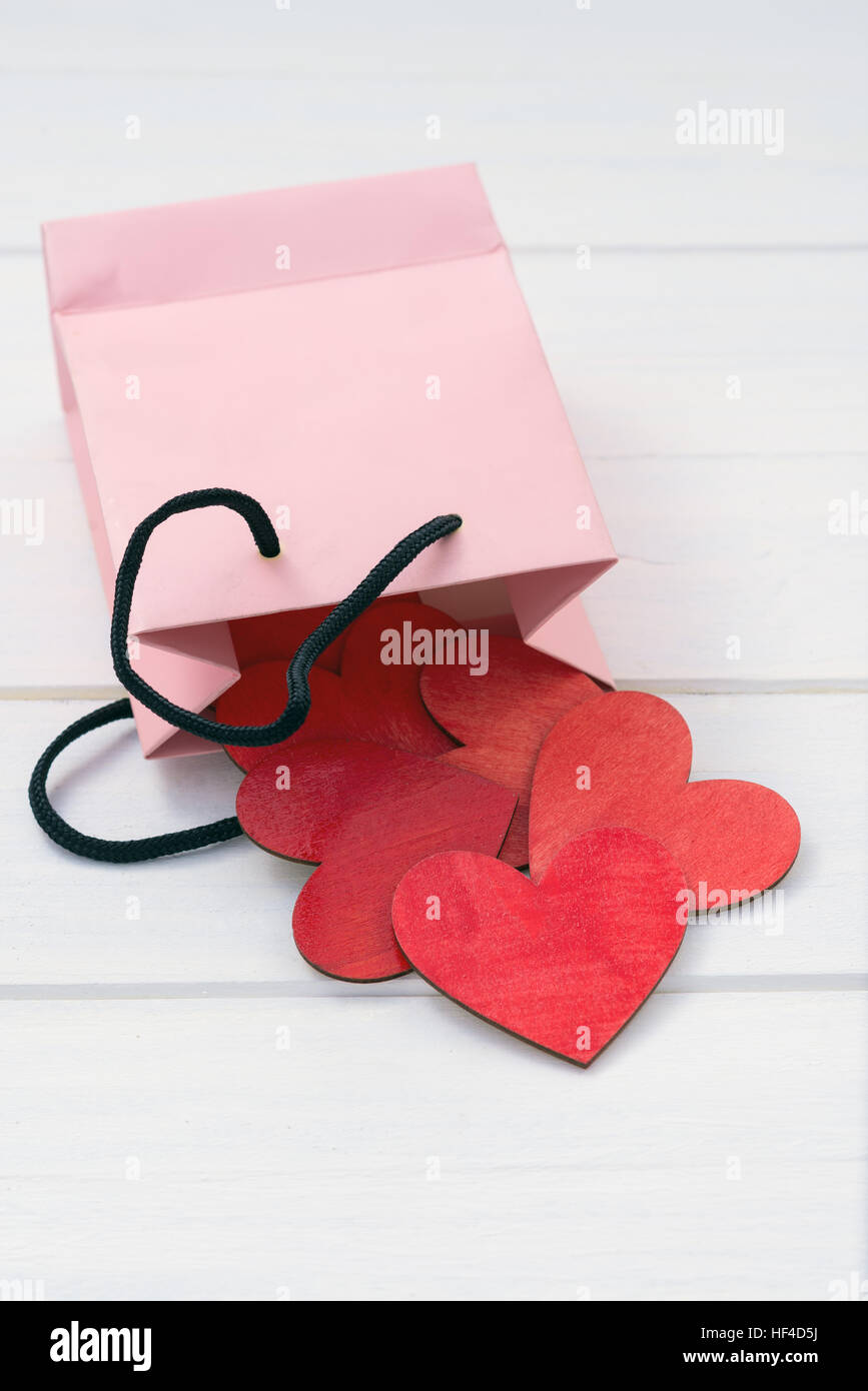 Paper bag pouring red hearts Stock Photo