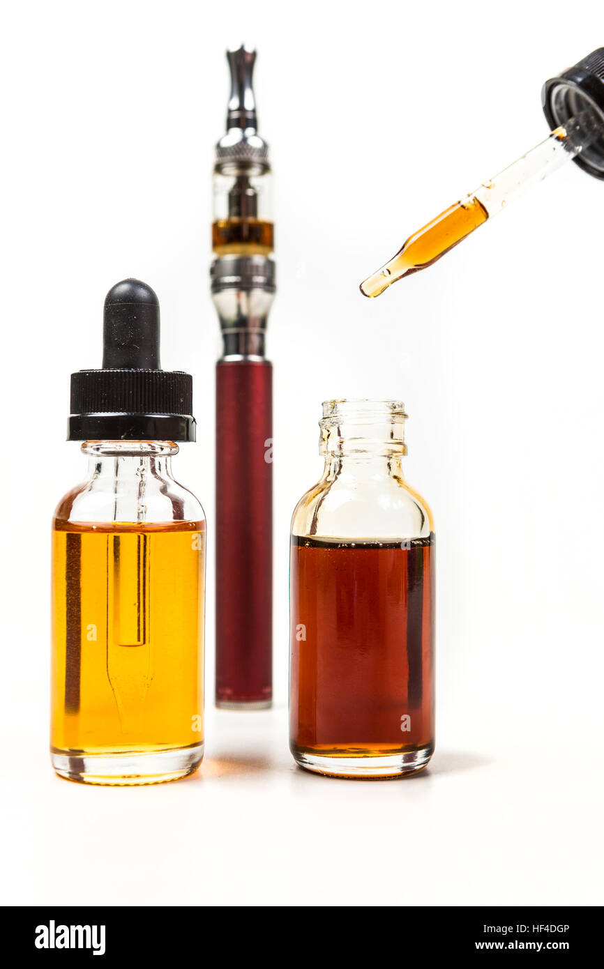 Assorted flavors vape juice and eyedropper being used isolated on white ...