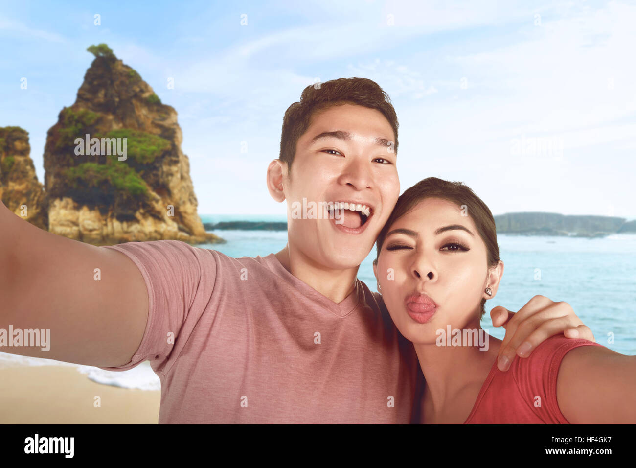 Happy asian couple is taking selfie photo on vacation on the beach ...