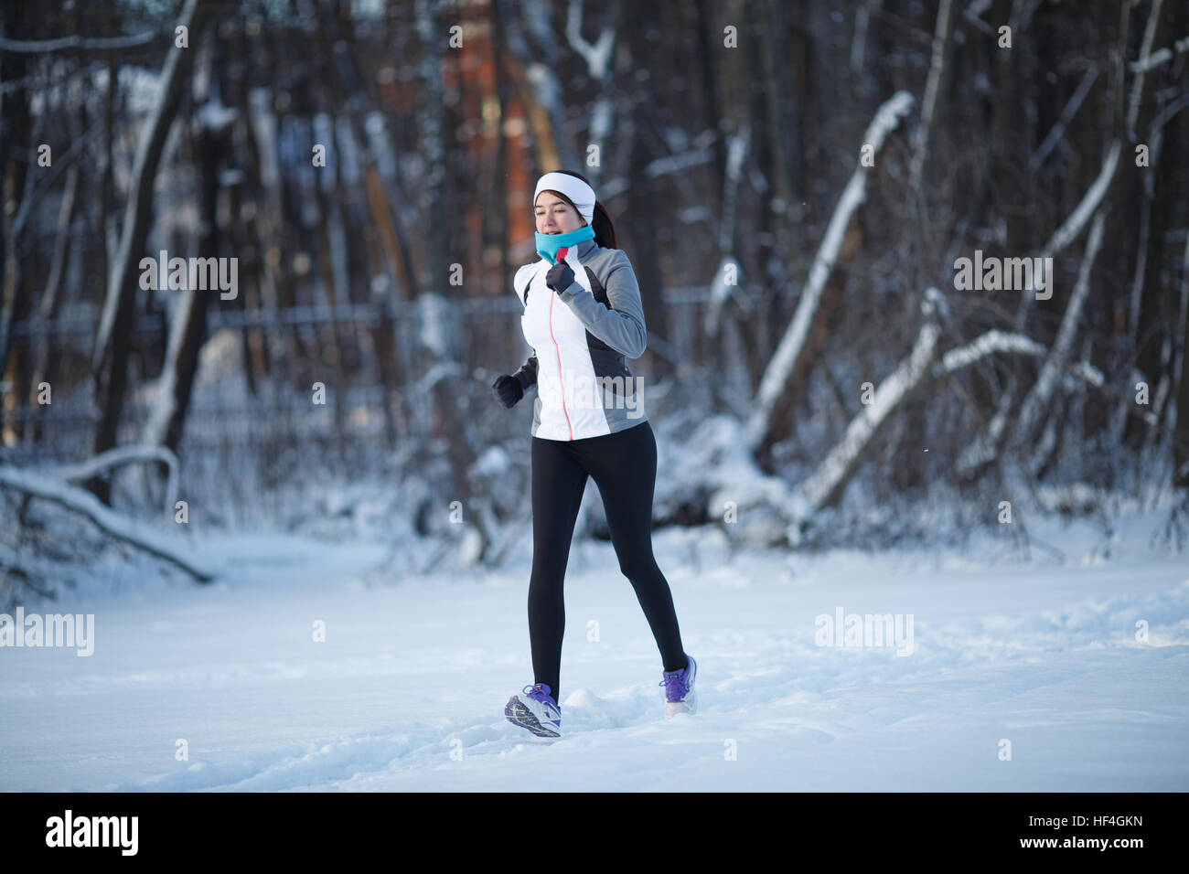 Young running in winter park among trees Stock Photo Alamy