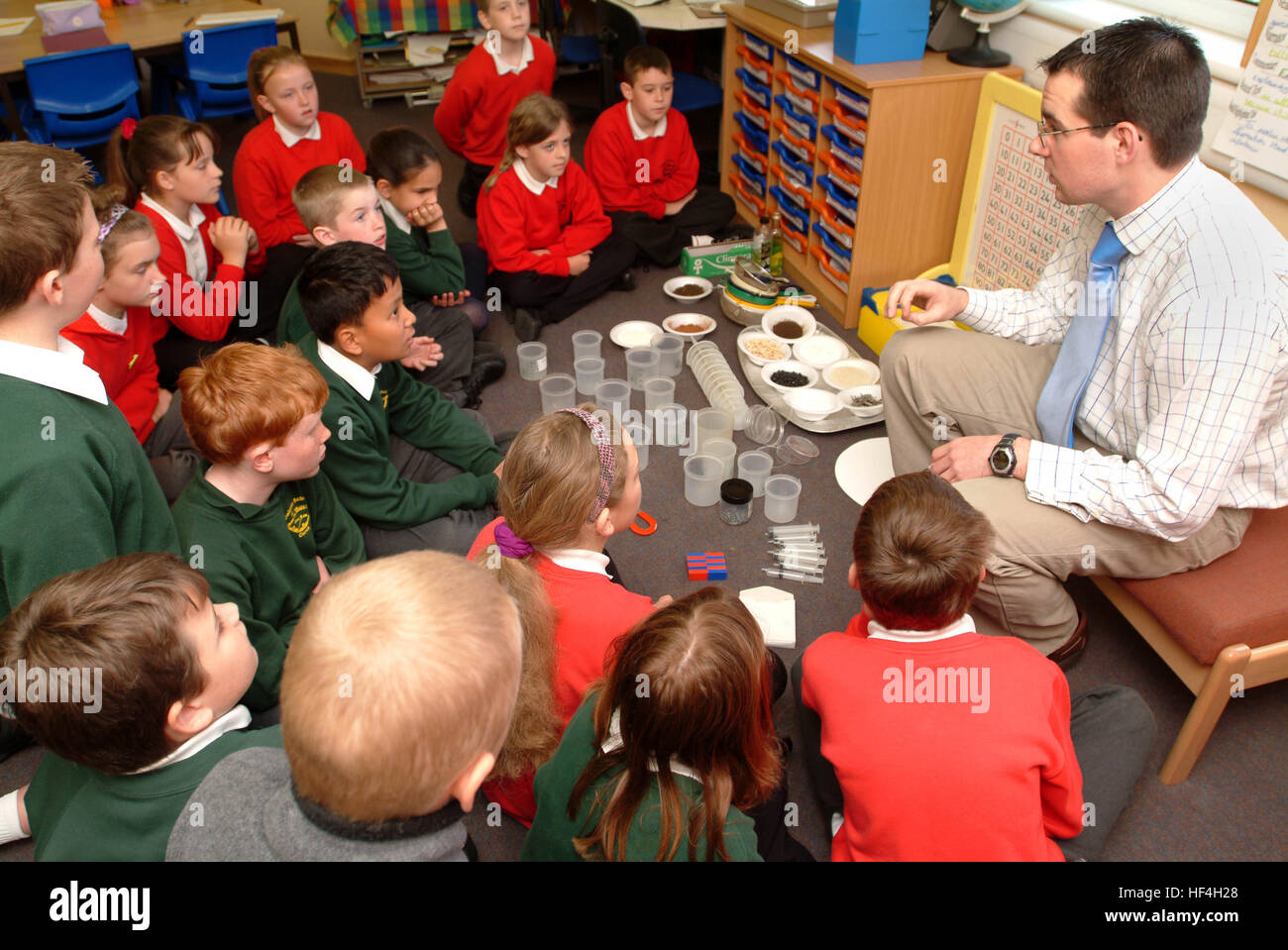 Student Using Magnet Students in a science class exploring magnetism with magnets and metal ...