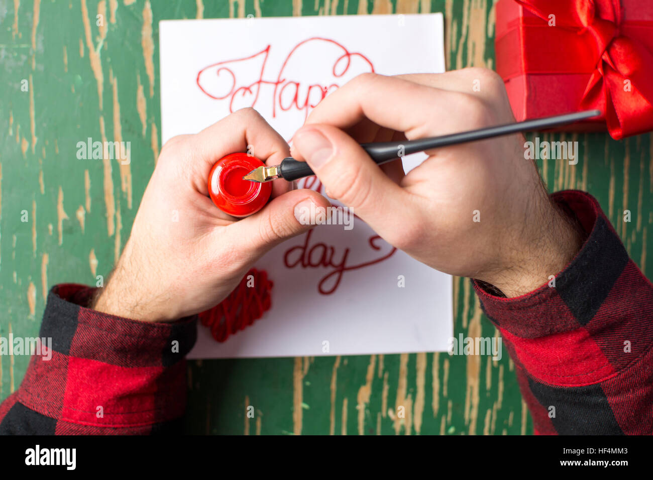 Male hands writing a calligraphy Valentines day card Stock Photo