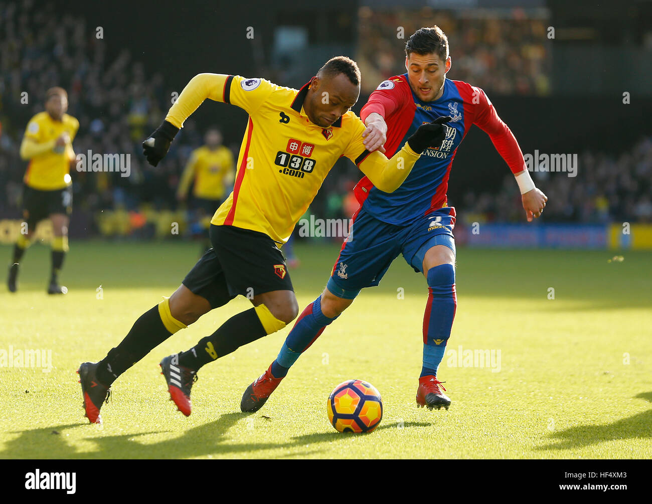 Watford's Juan Camilo Zuniga (left) and Crystal Palace's Joel Ward (right) battle for the ball during the Premier League match at Vicarage Road, Watford. Stock Photo