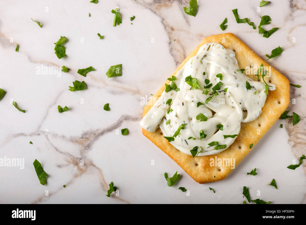 Thin crispy crackers with cream cheese and parsley Stock Photo Alamy