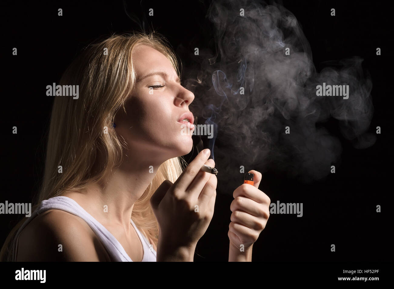woman smoking joint of marijuana on black background Stock Photo Alamy