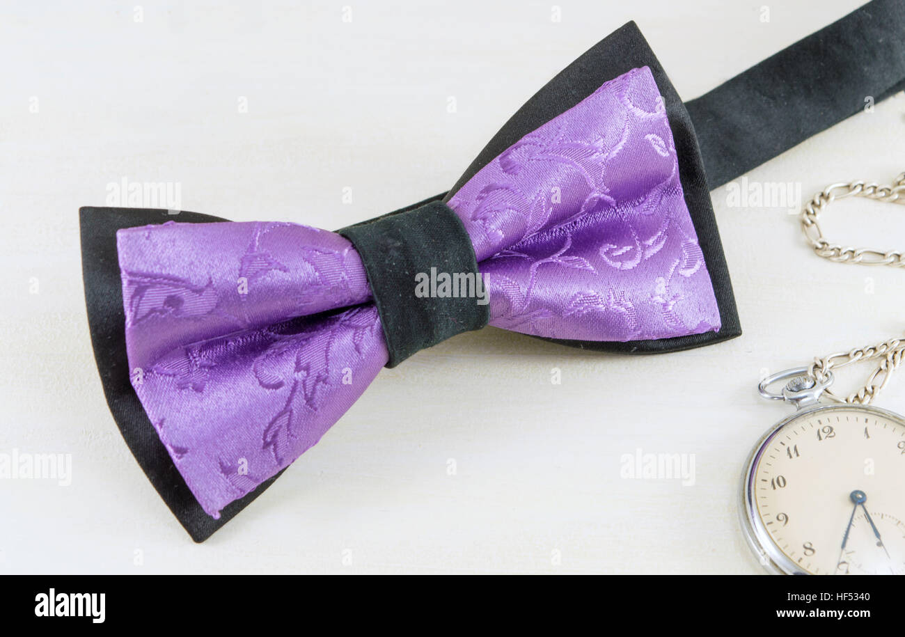 Purple elegant bow tie on wooden table Stock Photo