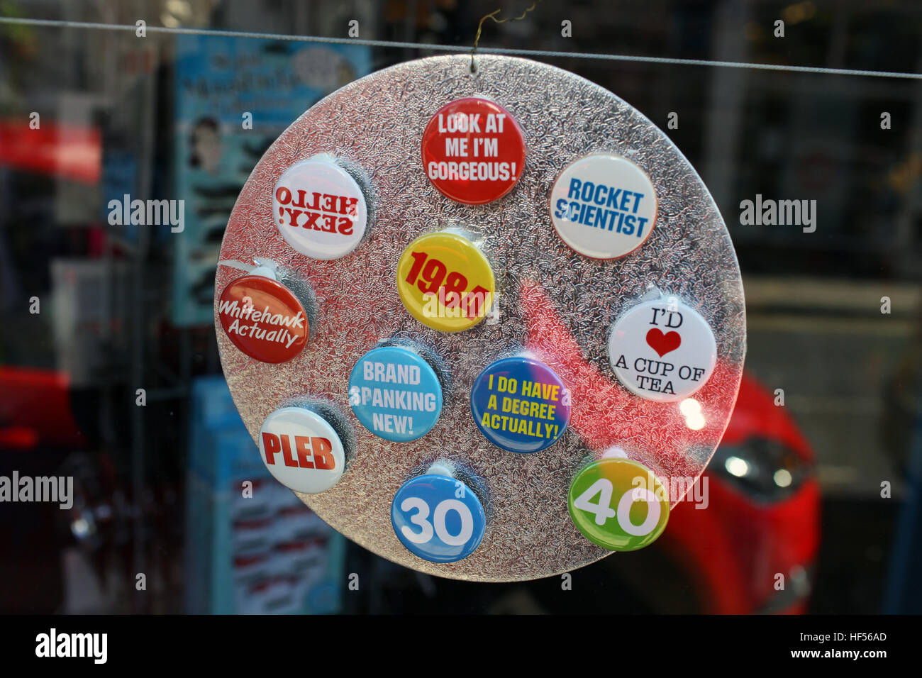 Novelty badges in a shop window Stock Photo Alamy