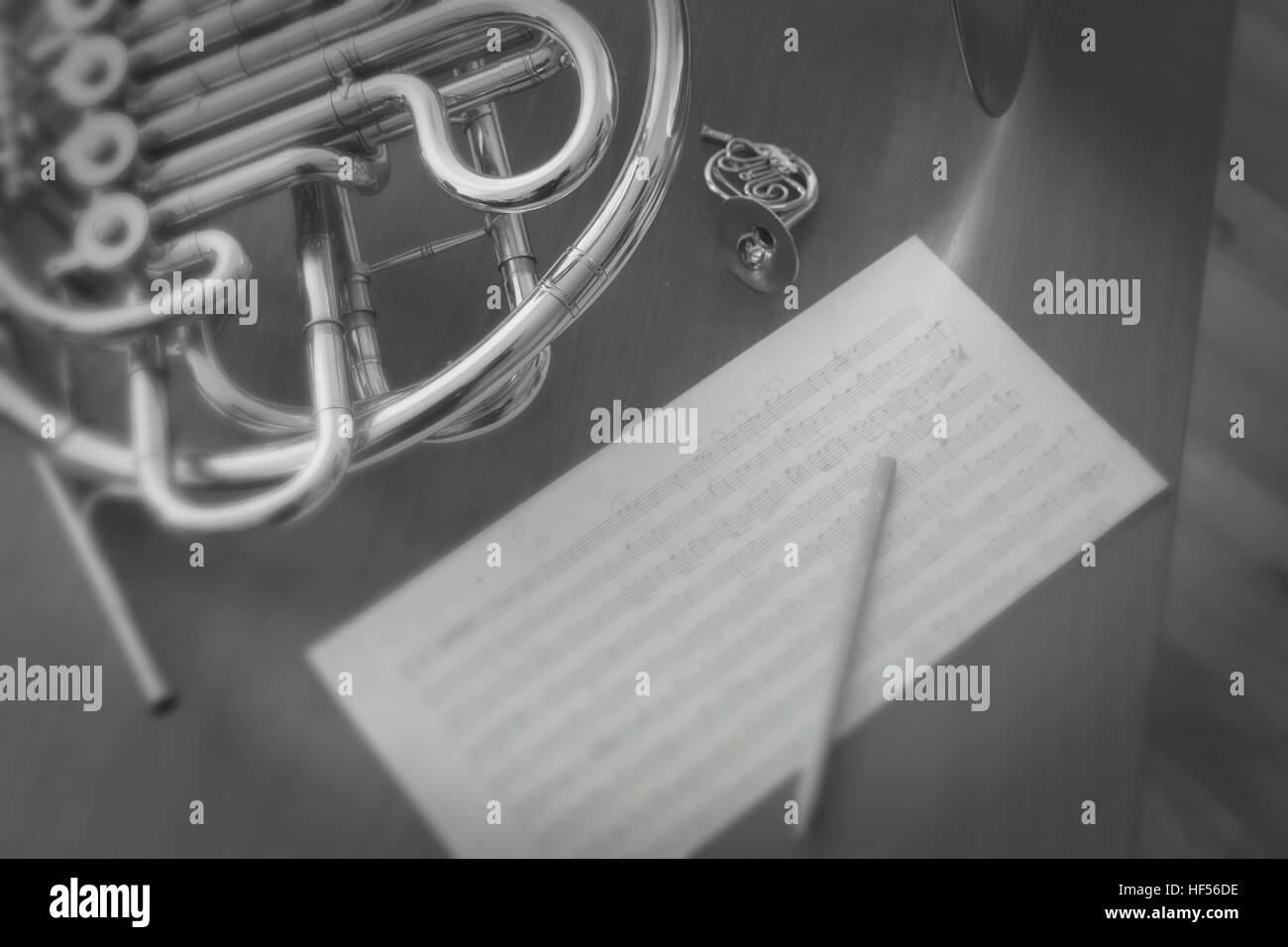 still life of my french horn, some sheet music and a french horn