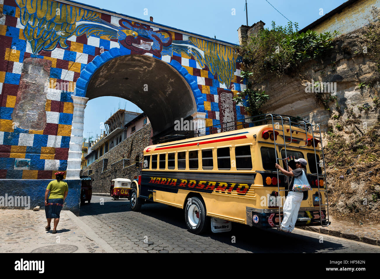 Chichicastenango, Guatemala - April 26, 2014: Bus with one man holding to a bar in the back entering the town of Chichicastenango, in Guatemala Stock Photo