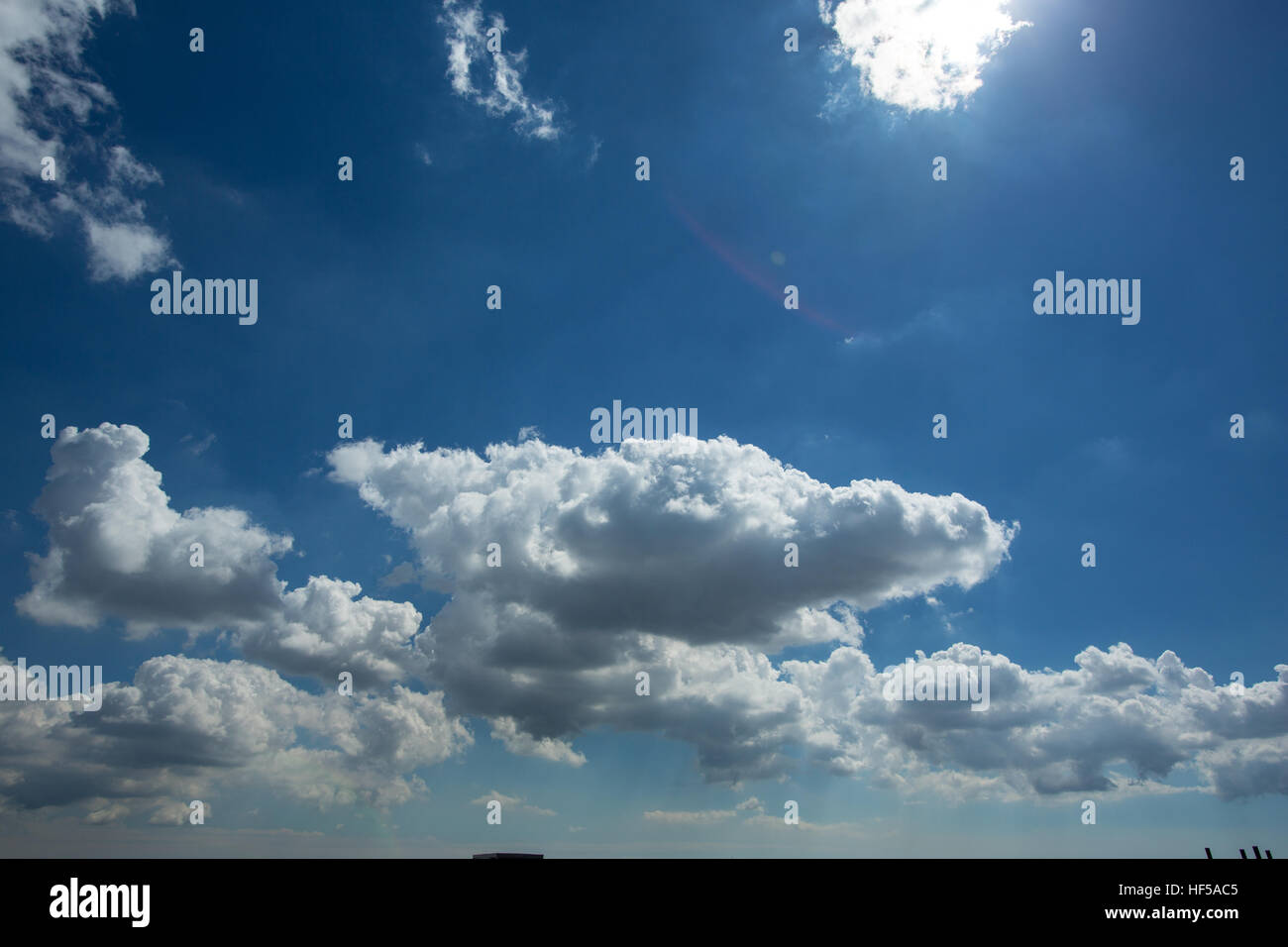 Puffy White Clouds in a Blue Sky Stock Photo - Alamy