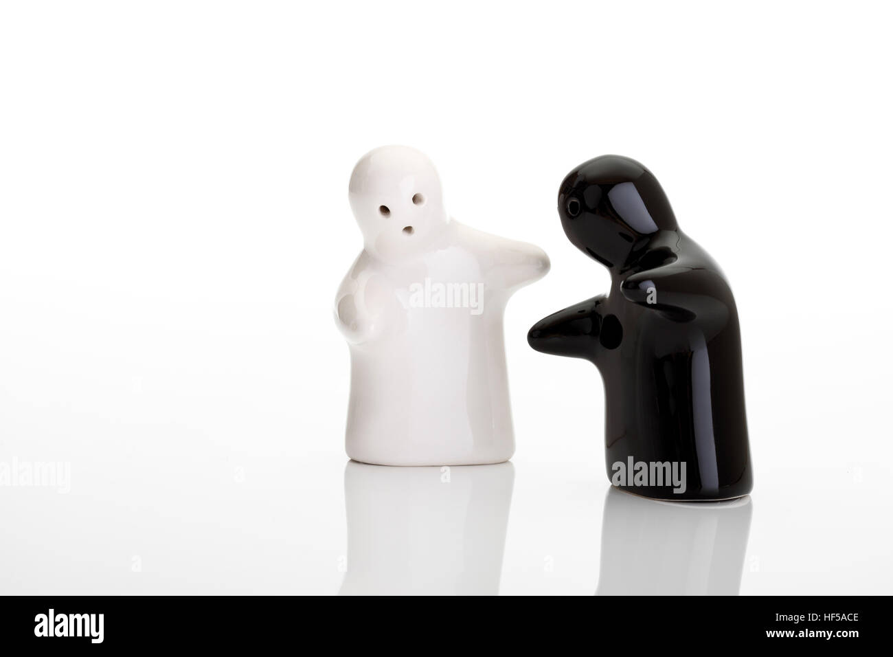 The encounter - symbolic picture - ghost salt and pepper shakers Stock Photo