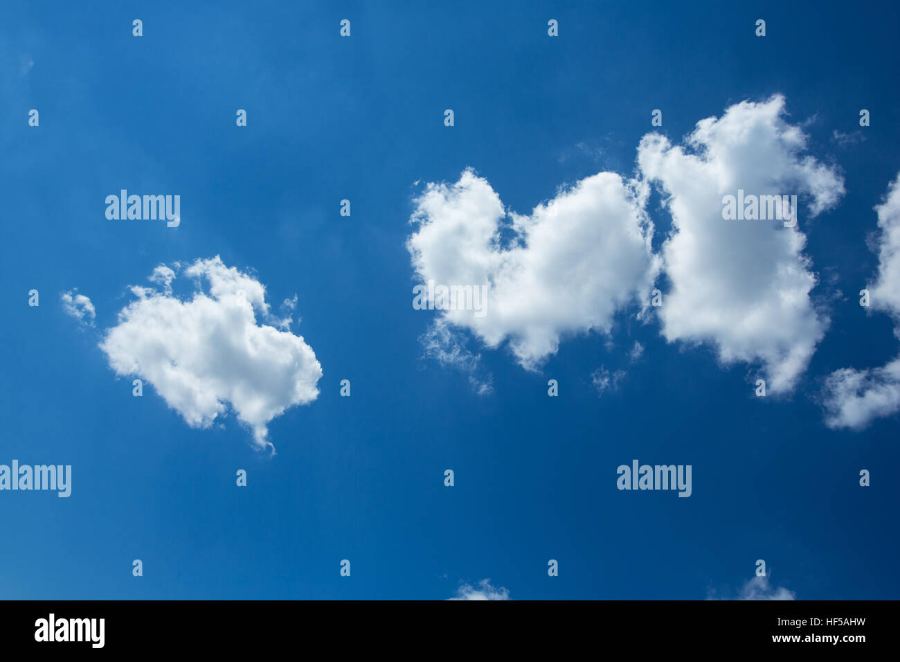 Puffy White Clouds in a Blue Sky Stock Photo - Alamy